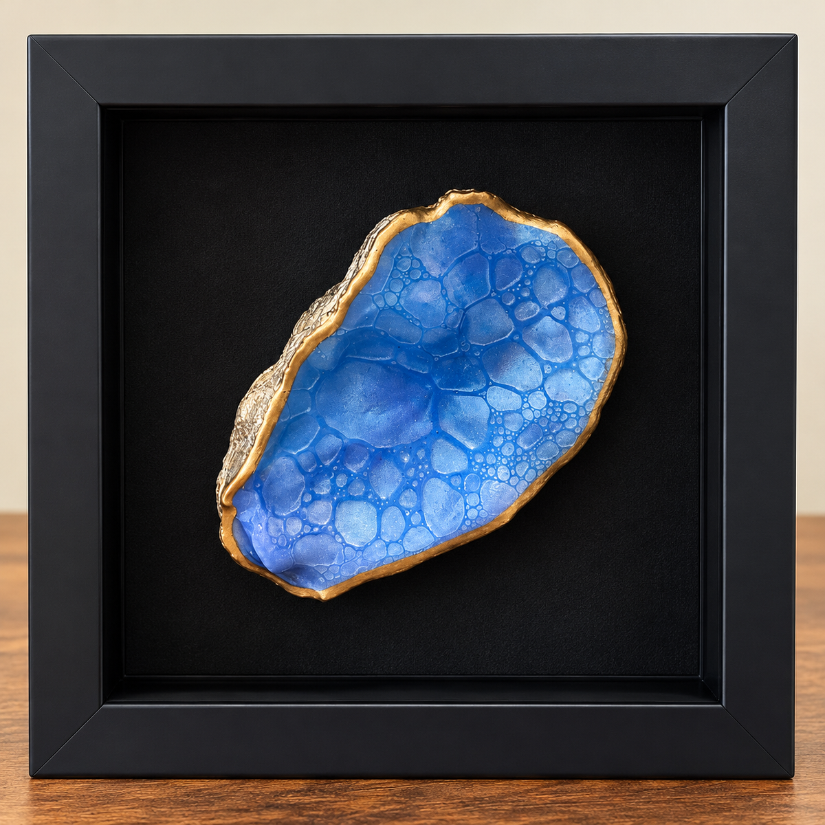 Handcrafted ocean blue bubble-effect oyster shell art in a black 6x6 shadow box