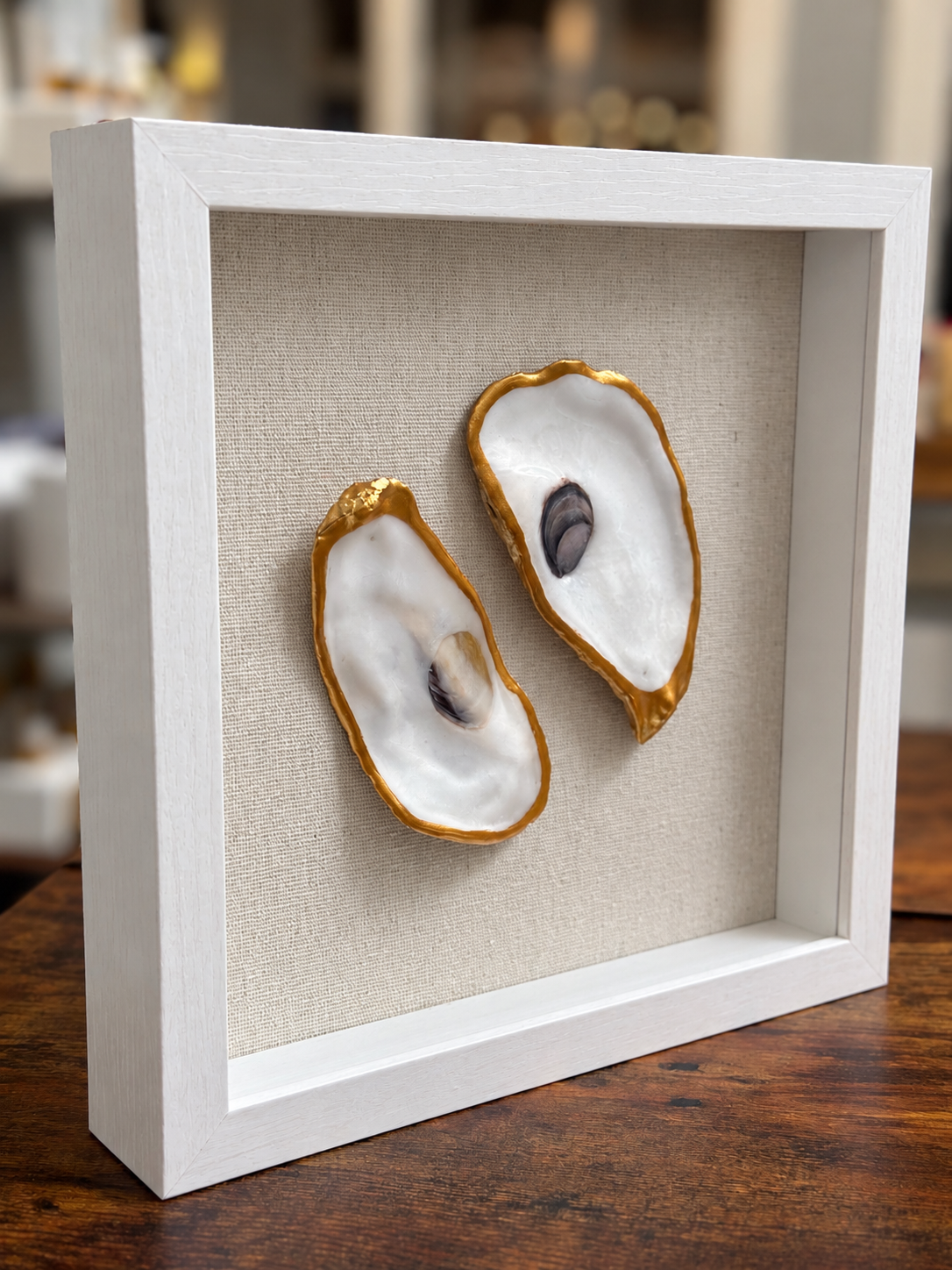 Side view of handcrafted double oyster shell art showing dimensional shells and whitewashed frame